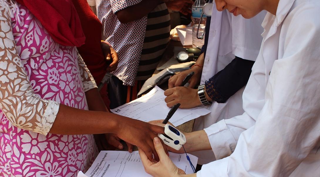A Global Gap volunteer measures pulse and oxygen saturation levels during a medical outreach in Nepal. A local woman has her pulse and oxygen saturation levels measured by a Global Gap Year volunteer in Nepal.